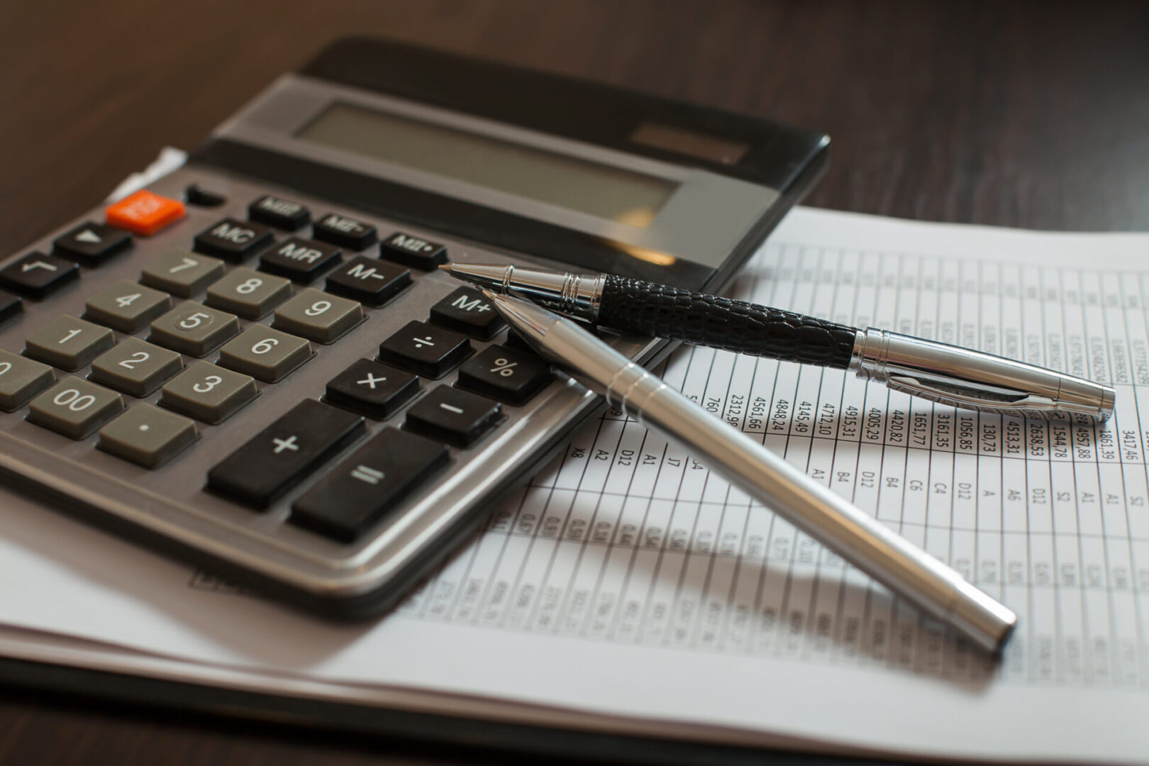 Office desk with calculator and pen