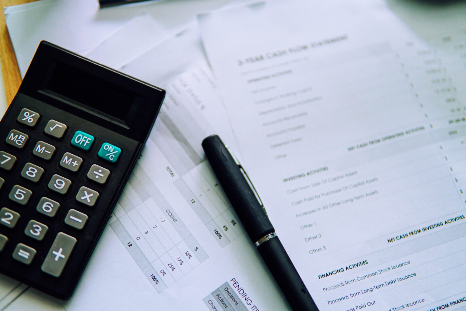 Calculator and financial documents on desk